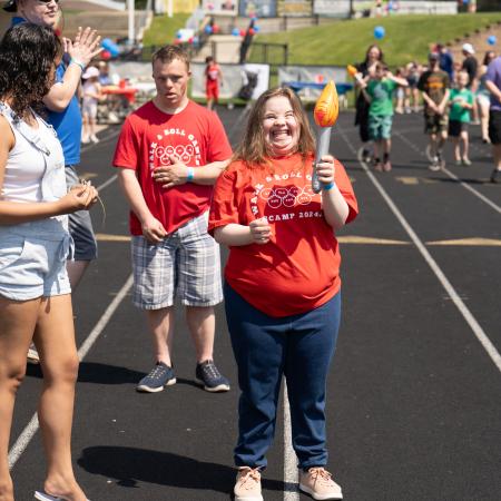 SCAMPer carrying Olympic Torch at Walk & Roll